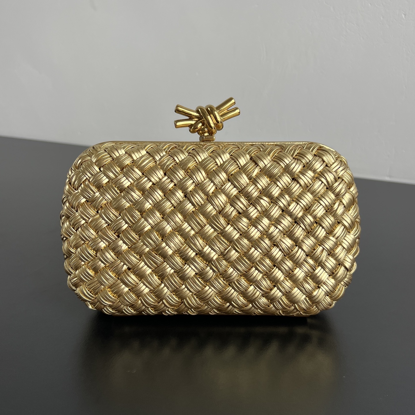 32fe0672 Bottega Veneta Knot Intrecciato clutch bag with a metallic knot clasp - Image 1